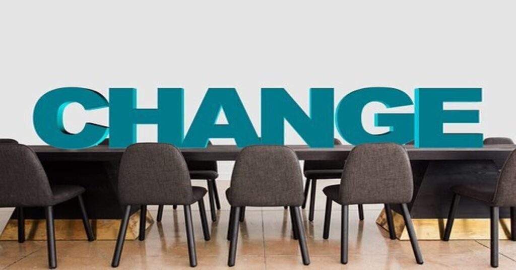 Conference room table with chairs and CHANGE written on table